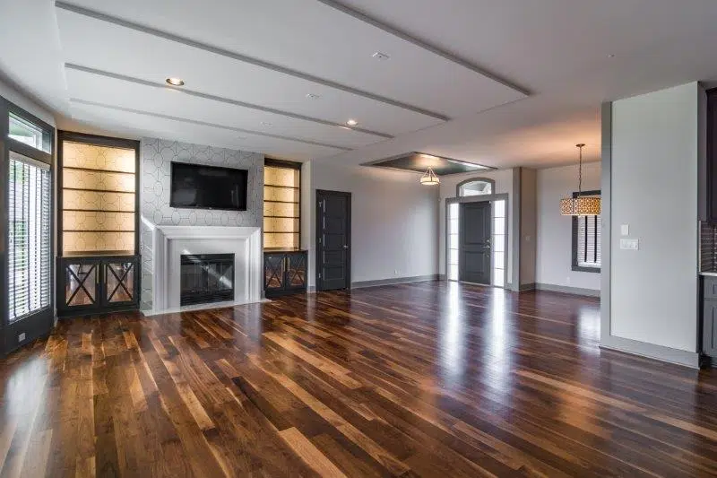 Justina Floor Plan Great Room With Hardwood Floors, Fireplace, And Built-in Cabinetry By Comerio Homes