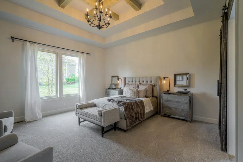 Lago Primary Bedroom With Tray Ceiling, Wood Beams, And Large Windows
