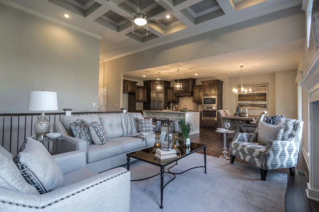 Madalena Great Room With Coffered Ceiling And Open-concept Kitchen By Comerio Homes