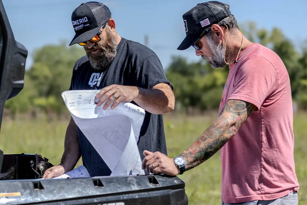 Damon Comerio Reviewing Residential Construction Blueprints On Site