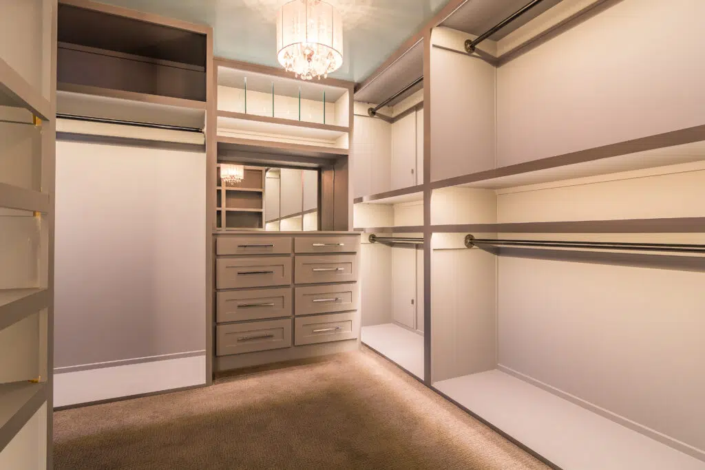 Justina Custom Walk-in Closet With Built-in Drawers, Shelving, Hanging Rods, And Accent Lighting.