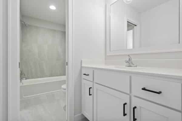 A view of a bathroom within the Milano floor plan, showcasing bright, modern finishes with polished nickel fixtures.
