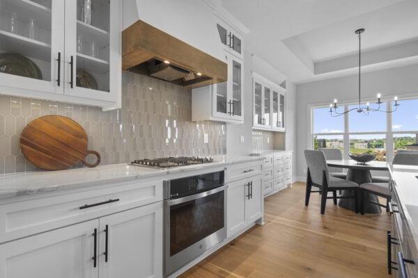 The kitchen of the Siena Story 1.5 home in Coventry Valley, showcasing modern range hood details and tile.