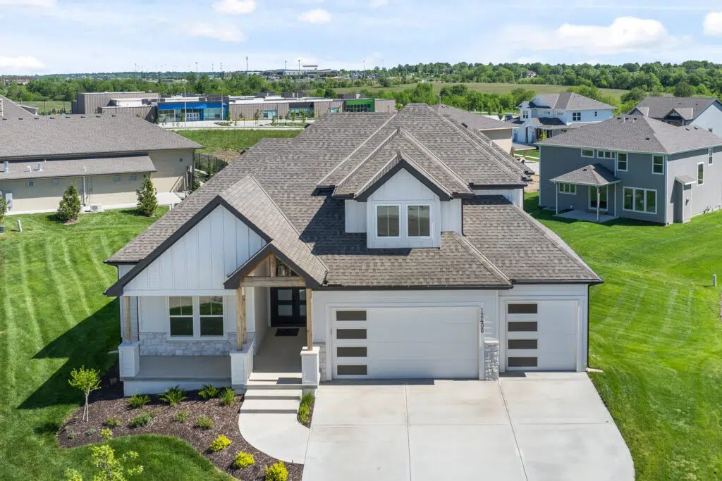Comerio Homes Siena 1.5 Front Exterior With Three-car Garage And Covered Entry.