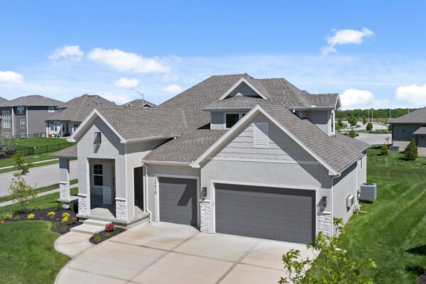 The Varese Ex home plan design with 3-car garage, columned entry and accent lighting fixtures.