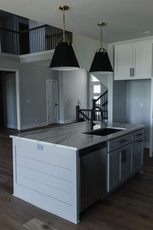 A view of the main entrance from behind the kitchen island of the Siena floor plan by Comerio Homes.