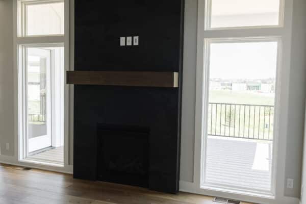 The feature fireplace, centrally located within the ground level of the Siena by Comerio Homes.