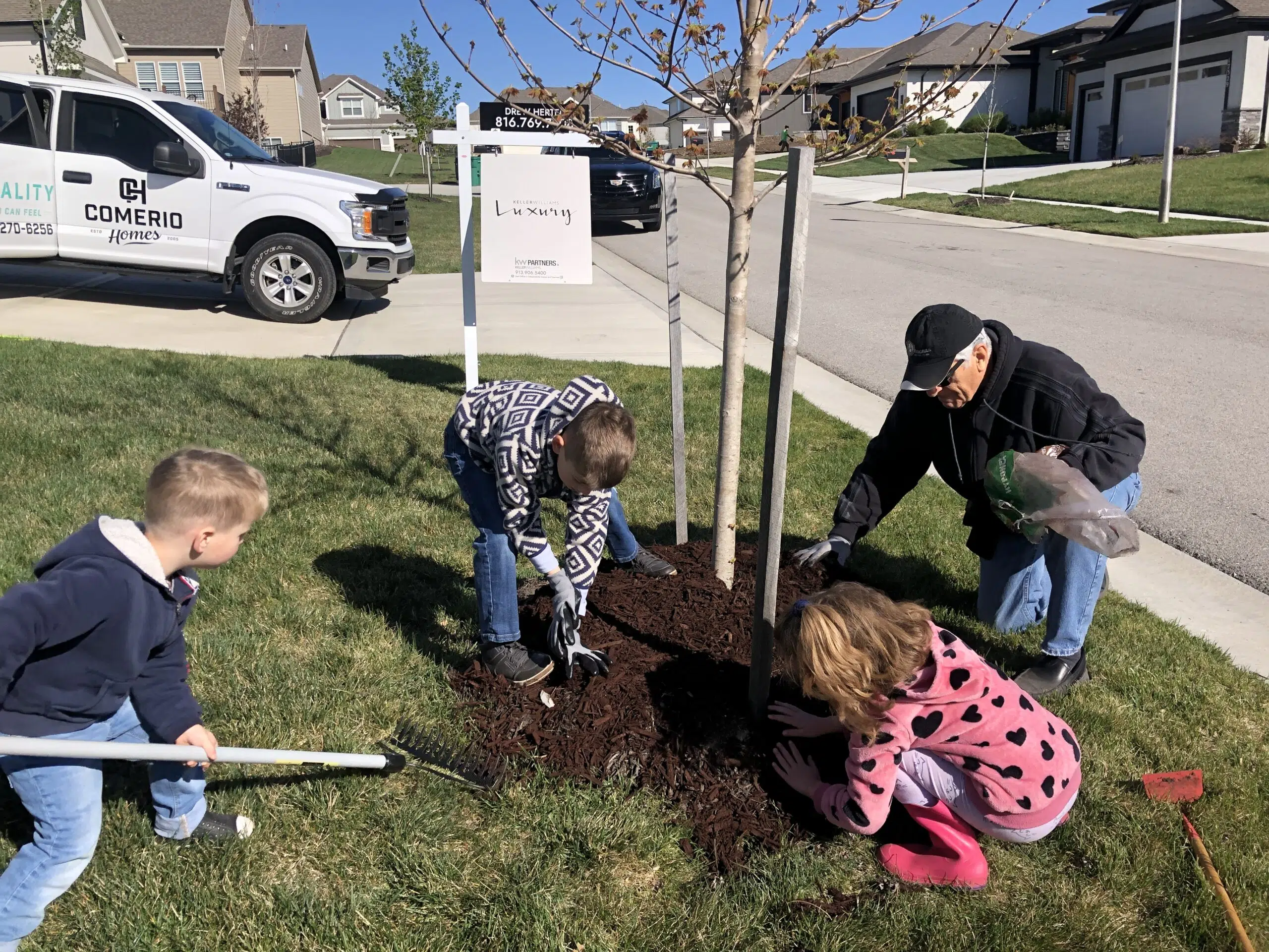 Comerio Family Members Planting A Tree Together In Tribute To Their Italian Roots And Family Heritage.