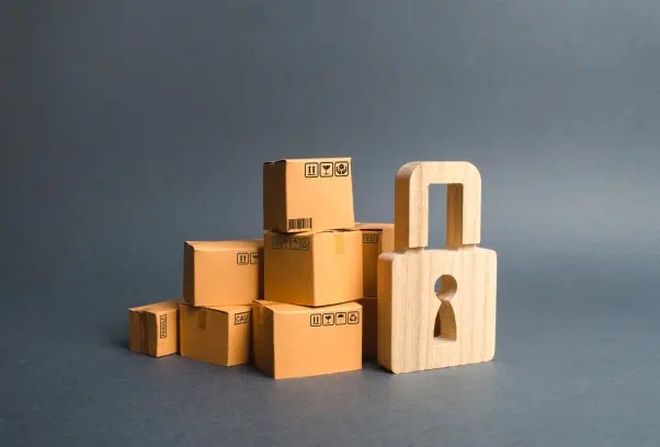 Home security concept with moving boxes and padlock
