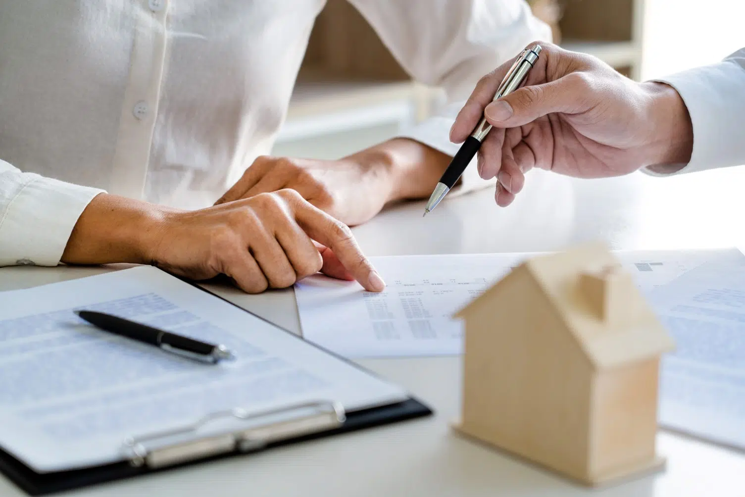 Homebuyer reviewing financing documents with a housing professional.