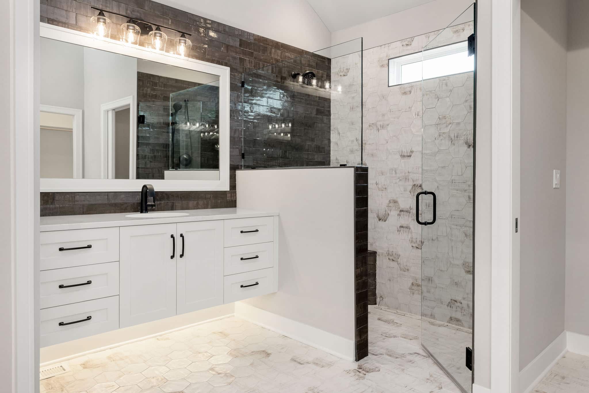 Madalena Zero Entry Shower Featuring Frameless Glass, Decorative Tile, Black Fixtures, And A Seamless Walk-in Design.