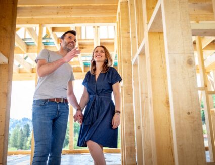 Buyers Touring A Home During A Framing Walkthrough With The Comerio Homes Builder