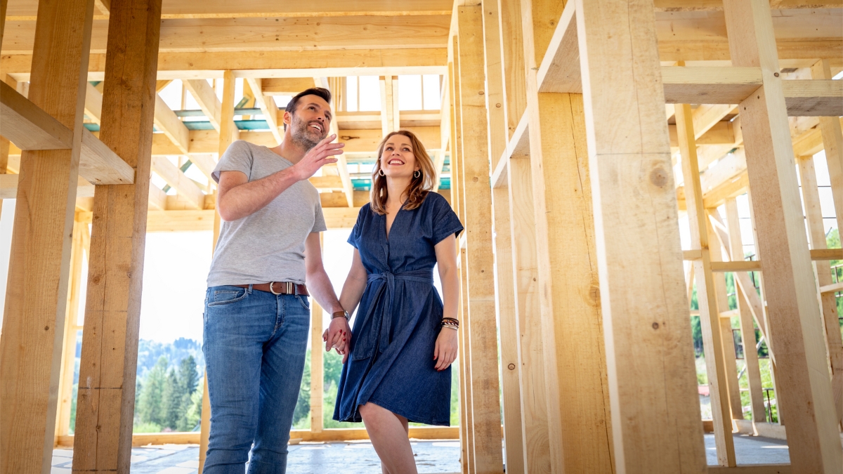 Buyers touring a home during a framing walkthrough with the Comerio Homes builder