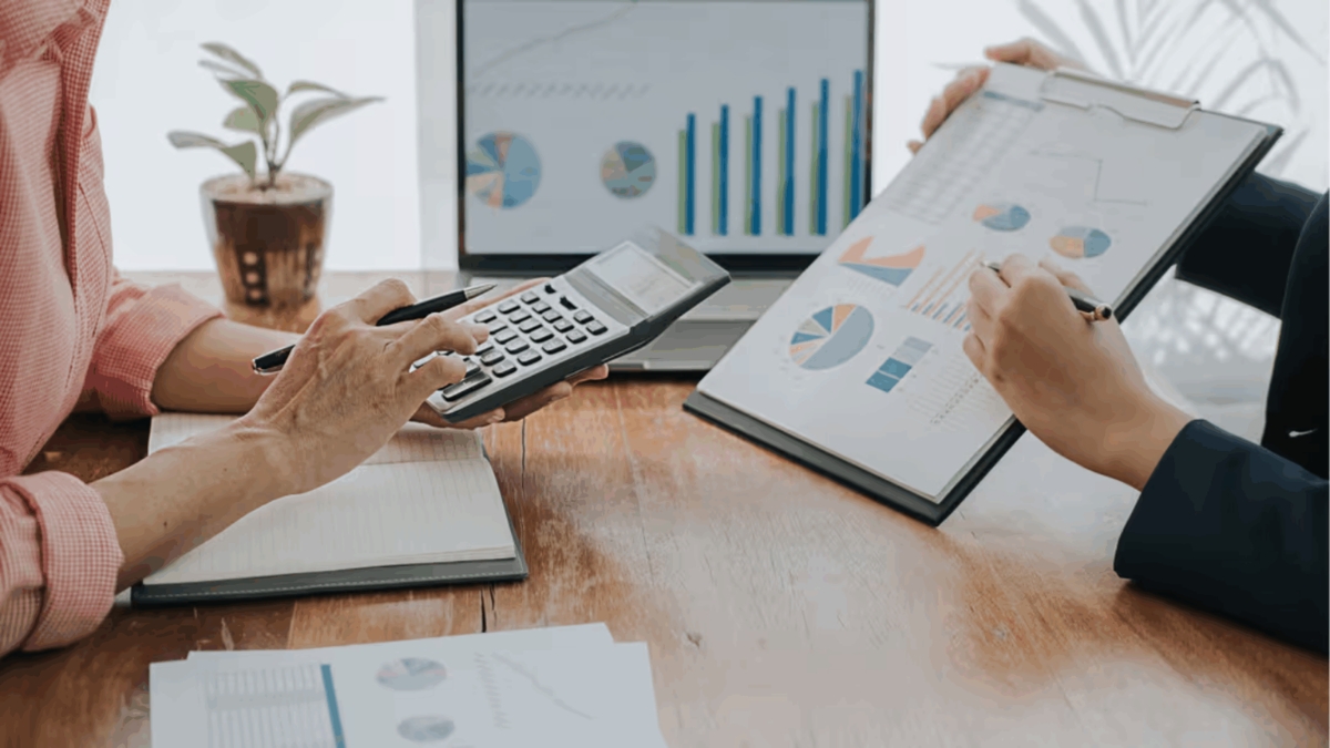 Reviewing cost charts and calculations for a new construction home budget with Comerio Homes