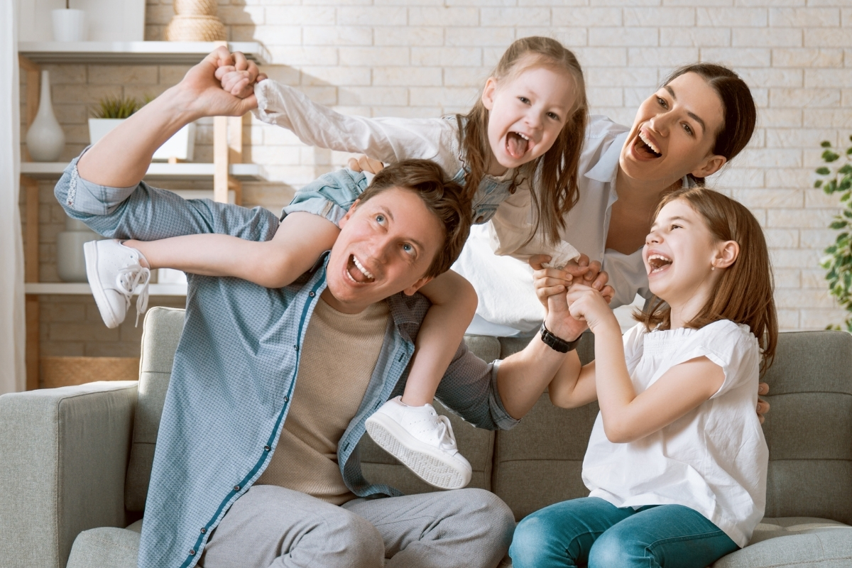 Family At Home In A Residence Built By Johnson County Home Builders