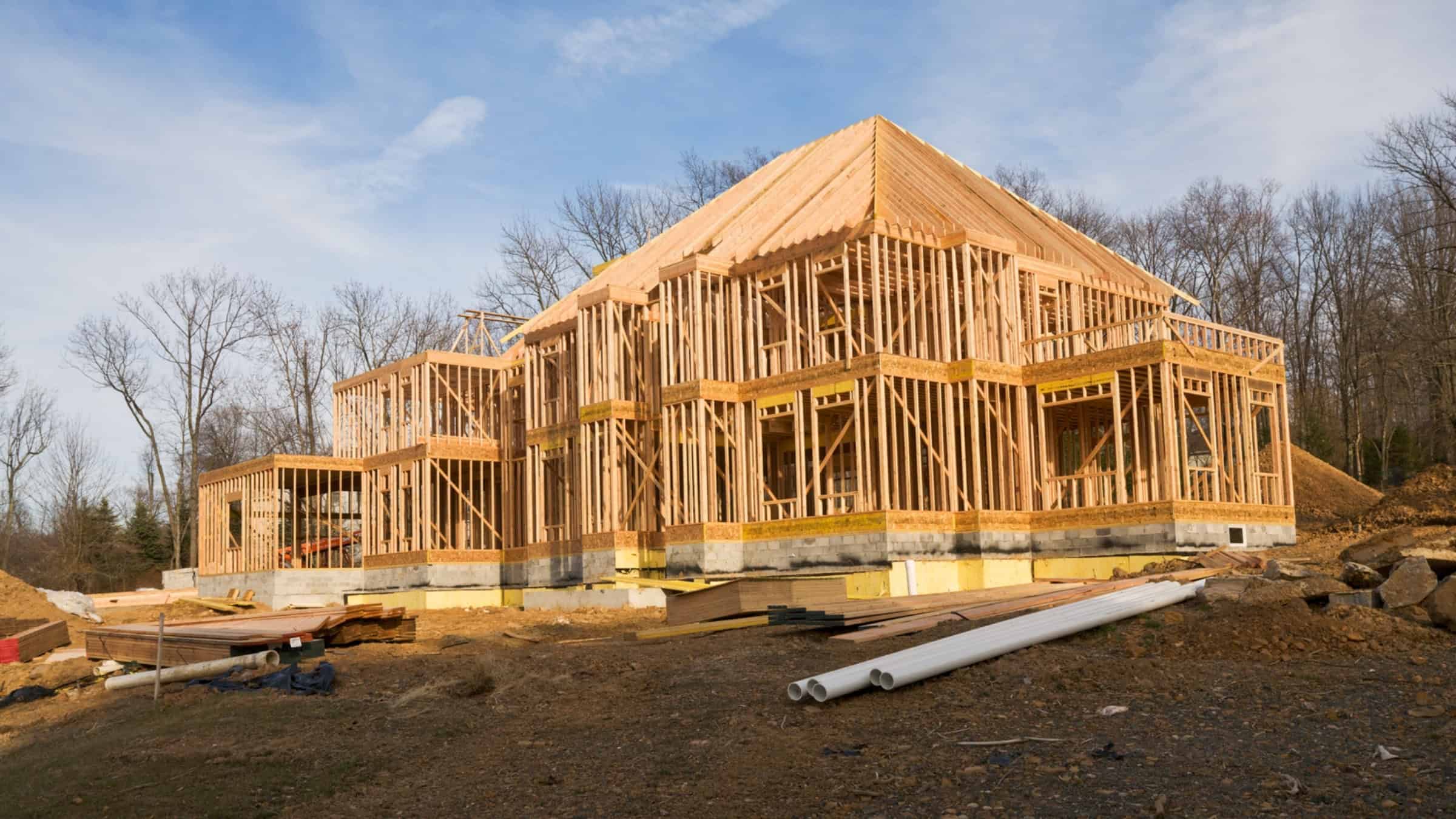New home framing and rough-in stage showing wood structure and early construction progress by Comerio Homes
