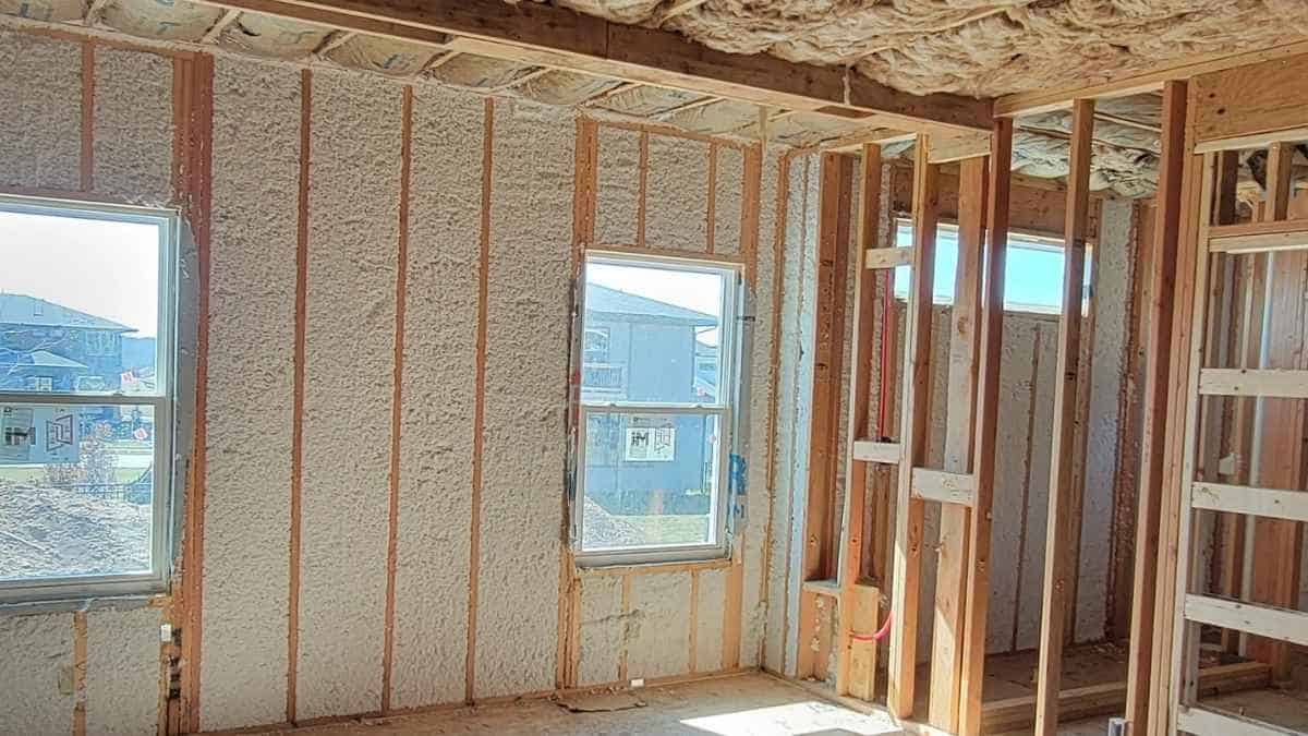 Home under construction showing framing and insulation installation by Comerio Homes