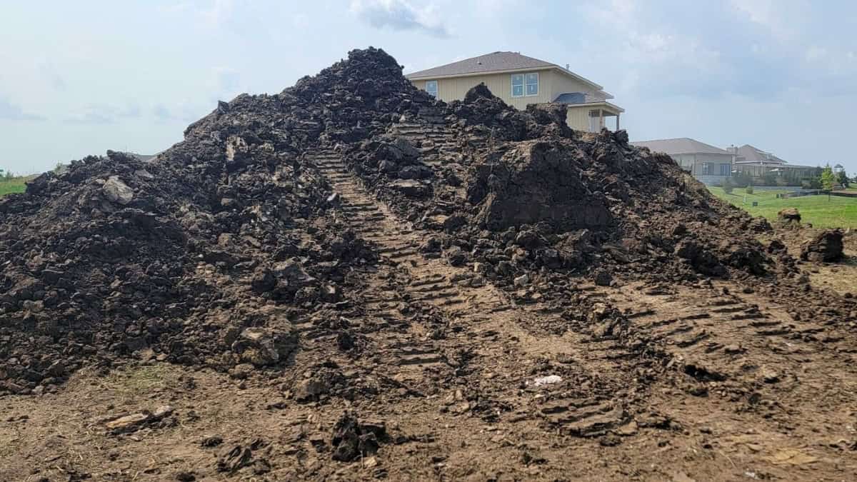 Construction site with excavation and dirt work showing early stage of home building by Comerio Homes