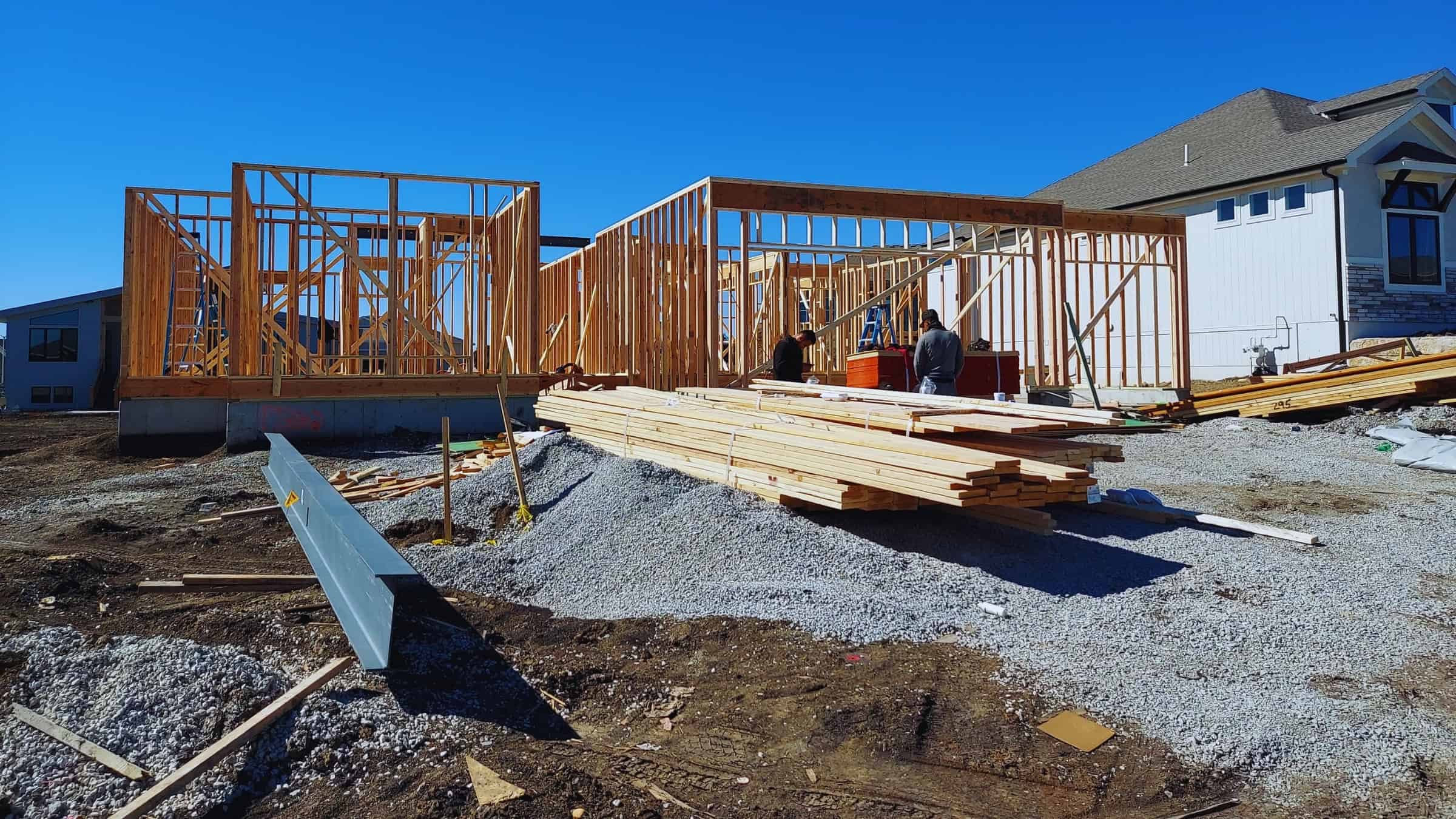 New home framing stage showing wood structure and construction progress by Comerio Homes