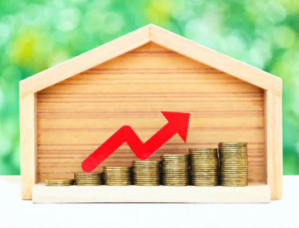 Rising Home Value Represented By House And Stacked Coins