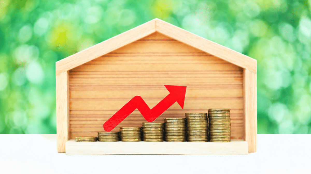 Rising Home Value Represented By House And Stacked Coins